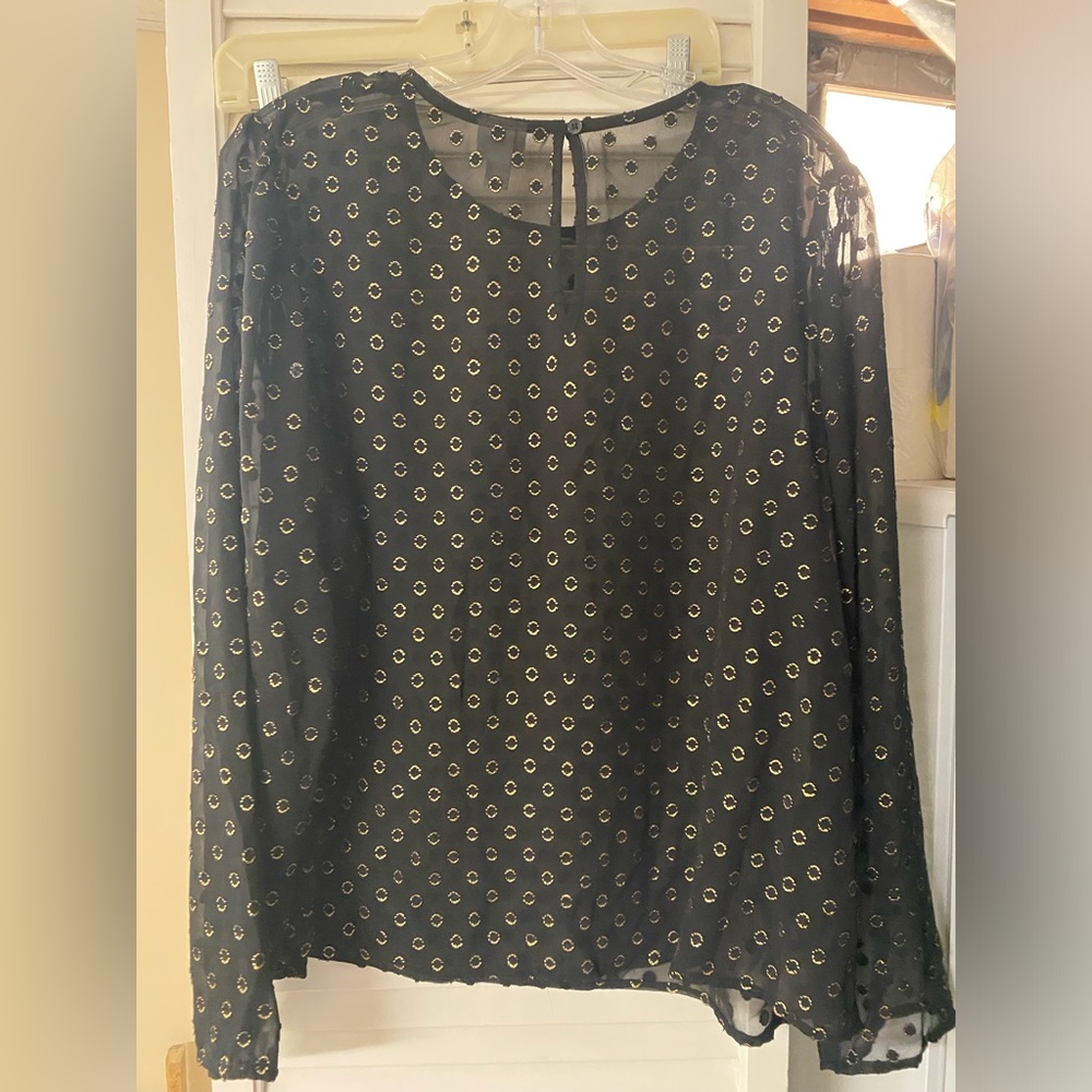 Black and gold blouse with circle detail.